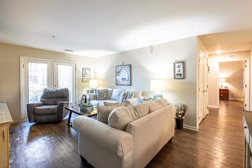 A living room with a couch, chair, and coffee table.