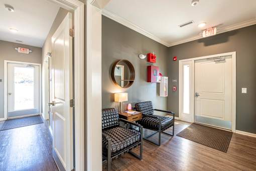 A hallway with a couch and a mirror on the wall.