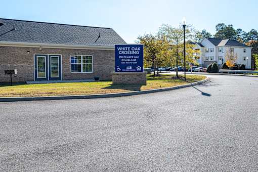 A sign in front of a building that says White Oak Crossing.