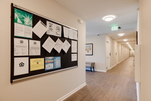 a bulletin board on a wall in a hallway