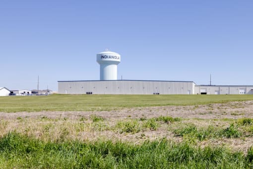 a water tower in the middle of a field
