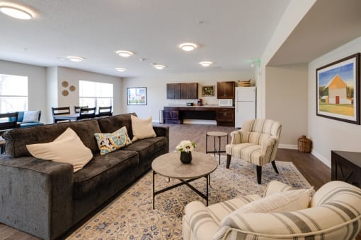 a living room with couches and chairs