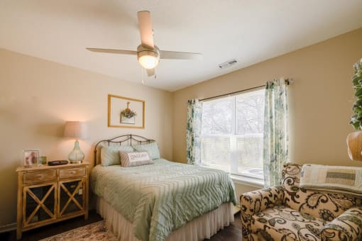 a bedroom with a bed and a chair