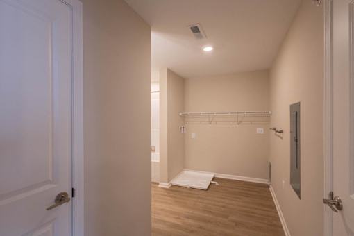 A long hallway with a door on the left and a door on the right.