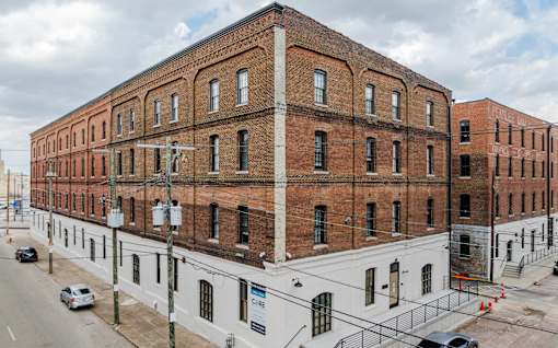 Exterior of Painters Row Apartments, a historic brick building in downtown Louisville, Kentucky.