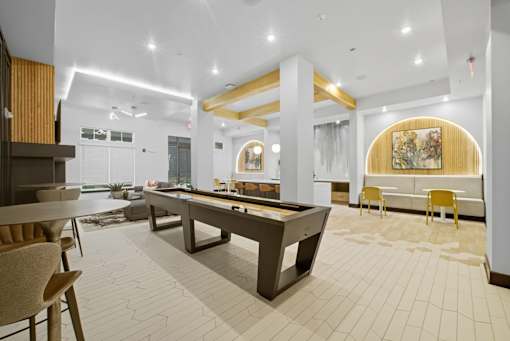A room with a pool table and a painting on the wall.