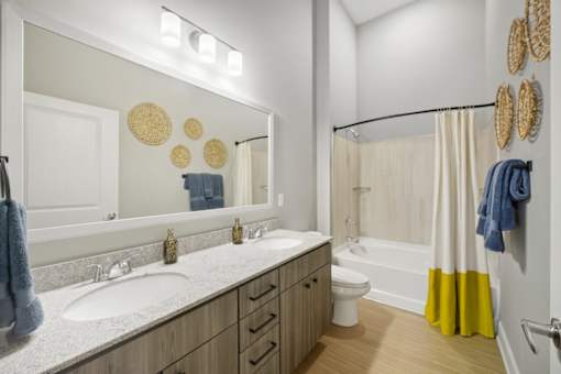 A bathroom with a white sink and a white toilet.