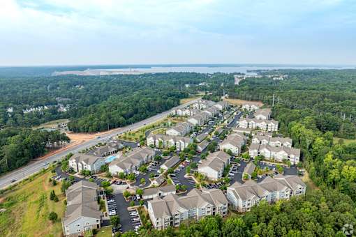 A bird's eye view of a residential area with houses and greenery.