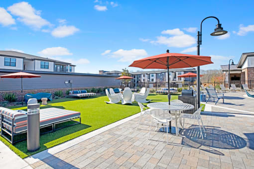 a patio with tables and chairs and umbrellas