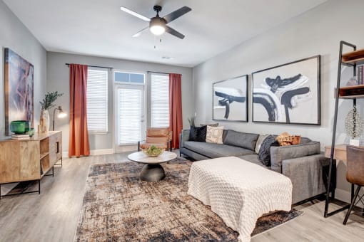 a living room with a couch and a ceiling fan