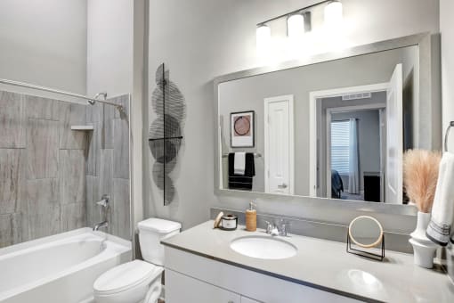 a bathroom with a sink and a mirror and a bath tub