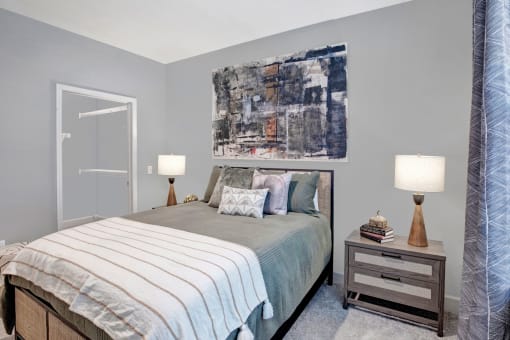 a bedroom with a bed and a painting on the wall