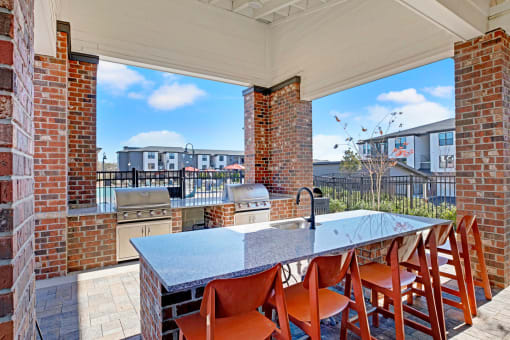 the kitchen has a large island with a granite counter top
