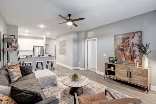 a living room with a couch and a ceiling fan