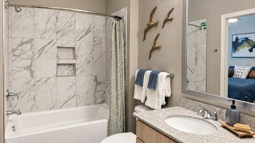 A bathroom with a marble tub and sink.