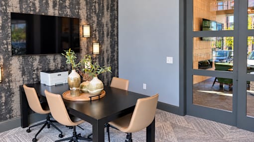 Business center with a shared worktable and chairs at Argento at Three86 in Gallatin, TN.