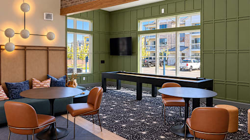 A room with a green wall and a black piano.