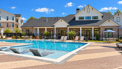 A large house with a pool in front.