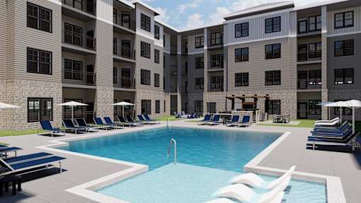 A large swimming pool is surrounded by lounge chairs and umbrellas in front of a building.