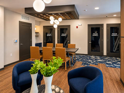 Business center with private focus rooms and collaborative workspace at Argento on the Broad apartments in Arden, NC