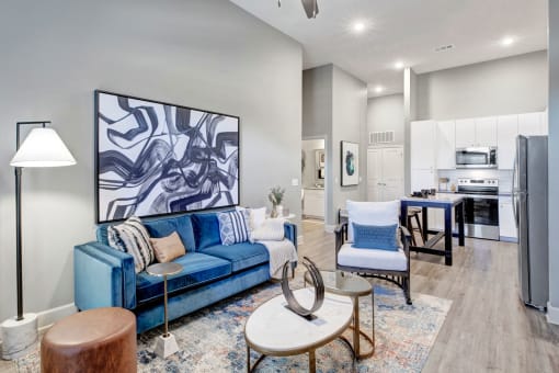 a living room with a blue couch and a table
