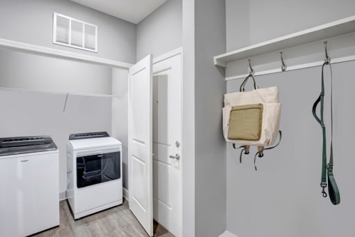 a laundry room with a stove and a door to a closet