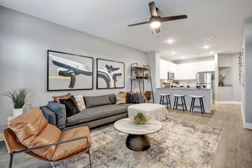 a living room with a couch and a kitchen in the background