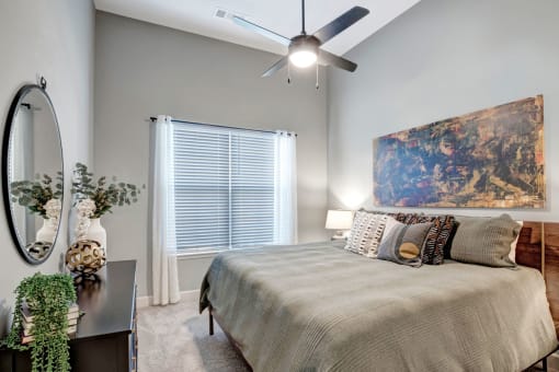 a bedroom with a bed and a ceiling fan