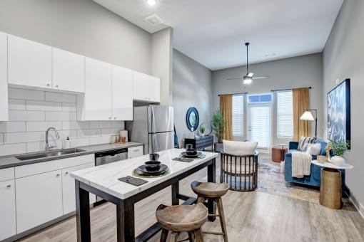 an open kitchen and living room with a table and chairs