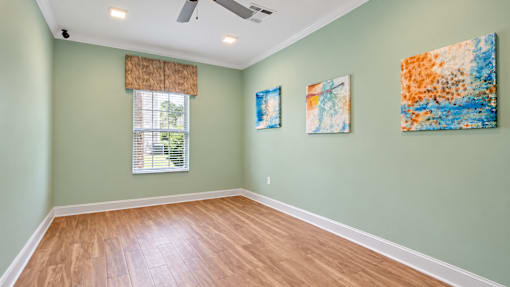 Yoga room with wood-look flooring, pale green walls and a window at Canterbury Apartments in Myrtle Beach, SC.