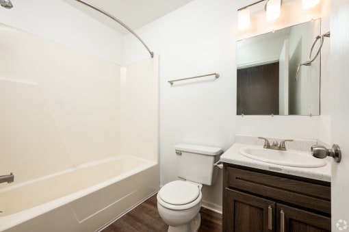 a bathroom with a sink toilet and a bath tub