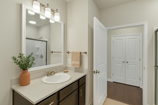 A bathroom with a sink, mirror, and a door.
