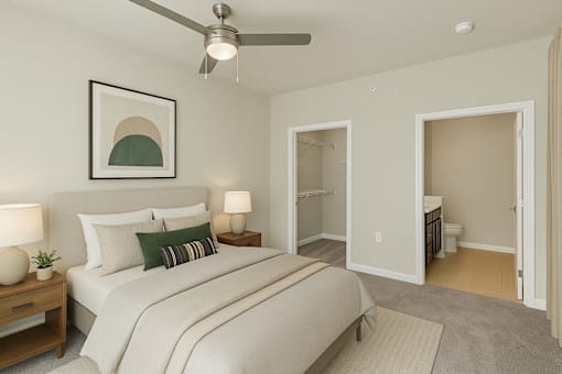 A bedroom with a bed, nightstands, and a ceiling fan.