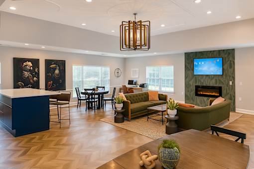 A living room with a fireplace and a TV on the wall.