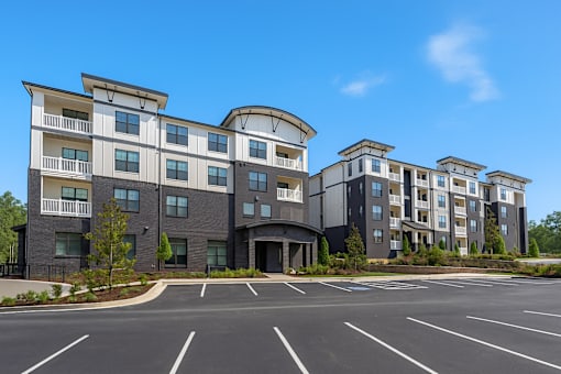 A large building with a parking lot in front of it.