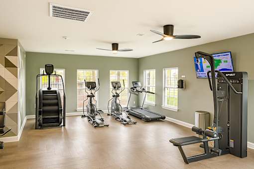 A spacious home gym with a variety of exercise equipment.