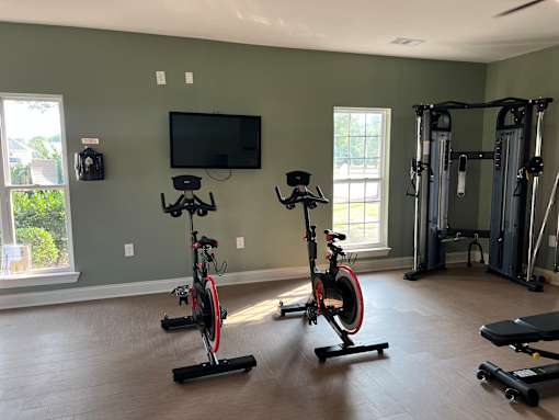 A home gym with exercise equipment and a television.