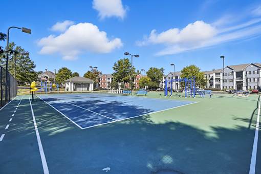 A tennis court with a blue surface and white lines.