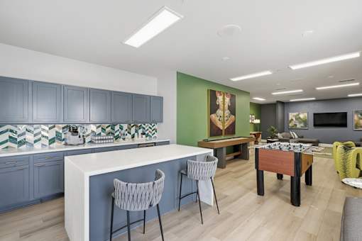 A kitchen with a bar area and a dining table.