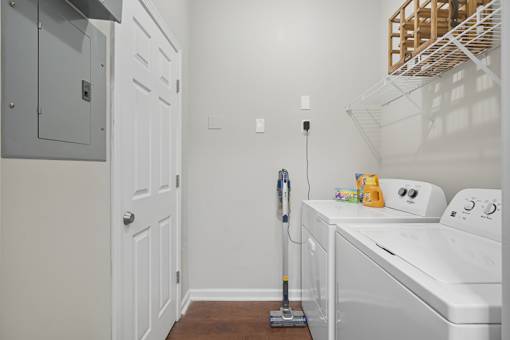 A white washer and dryer in a small laundry room.
