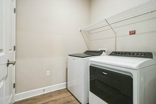 A white oven and microwave are sitting on a shelf in a kitchen.