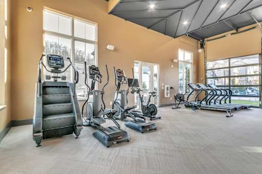 A gym with treadmills, elliptical machines, and a stair climber.