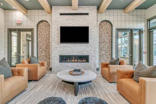 A living room with a fireplace and a television above it.