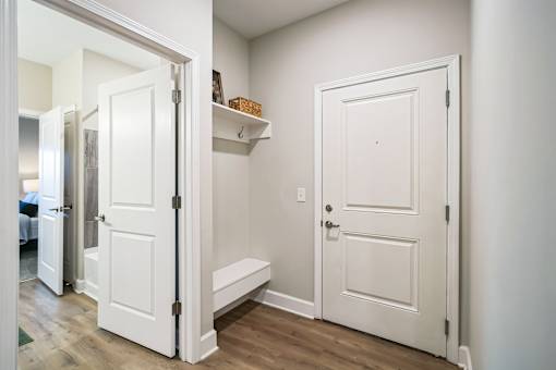 A white door is open to a hallway.