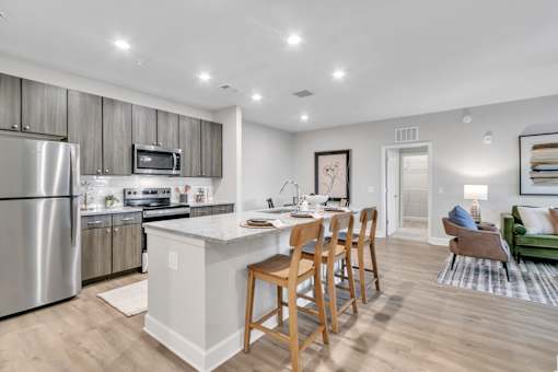 A modern kitchen with a dining table and chairs.