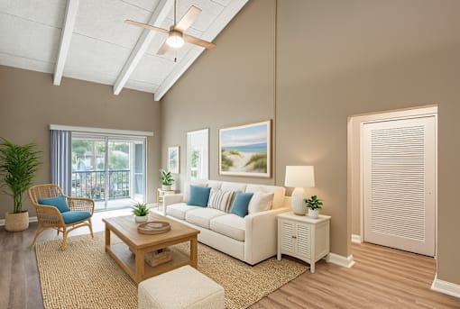 A living room with a white couch, a wooden coffee table, and a ceiling fan.