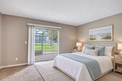 Virtually staged bedroom with coastal furnishings at Waterchase Apartments in Largo, FL.
