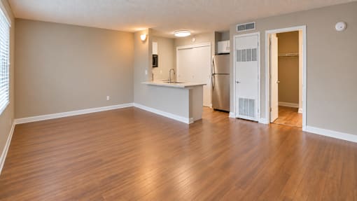 Unfurnished studio showing the open living area, breakfast bar and kitchen at Waterchase Apartments in Largo, FL.