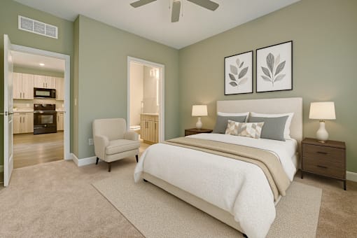 A bedroom with a large bed and a chair.