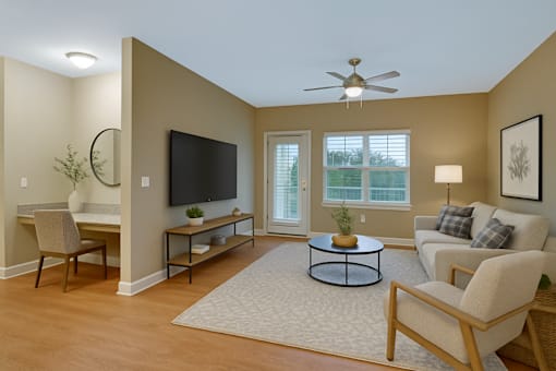 A living room with a television, a couch, and a coffee table.